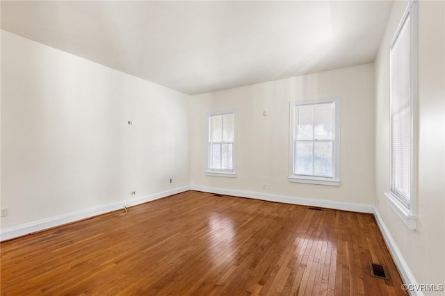 spare room featuring wood-type flooring