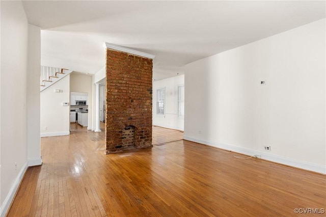 unfurnished living room featuring hardwood / wood-style flooring