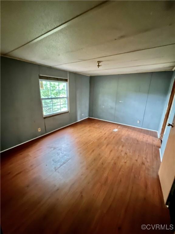 unfurnished bedroom with hardwood / wood-style floors