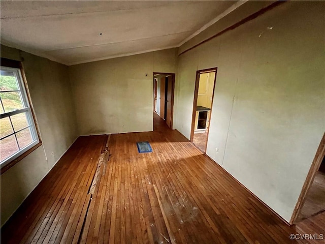 empty room featuring hardwood / wood-style flooring and lofted ceiling