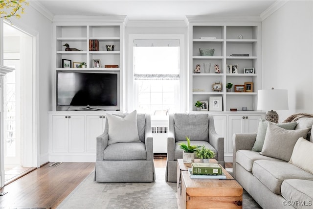 living room with hardwood / wood-style flooring, ornamental molding, and radiator