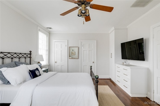 bedroom with dark hardwood / wood-style flooring, ornamental molding, and ceiling fan