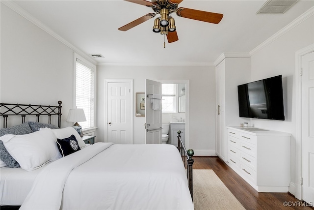 bedroom featuring sink, crown molding, ensuite bath, dark hardwood / wood-style flooring, and ceiling fan