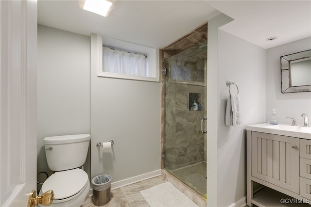 bathroom featuring vanity, a shower with door, and toilet