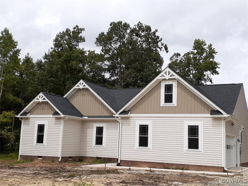 rear view of house with a garage