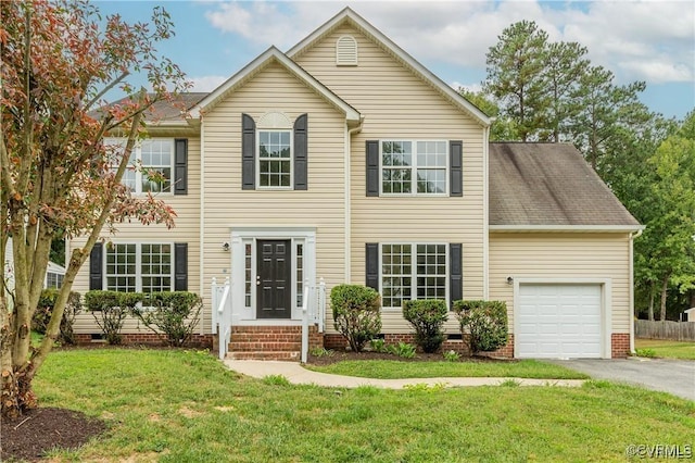 view of front of house featuring a garage and a front yard