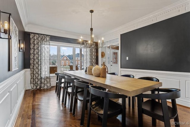 dining room featuring ornamental molding, a chandelier, and dark hardwood / wood-style flooring