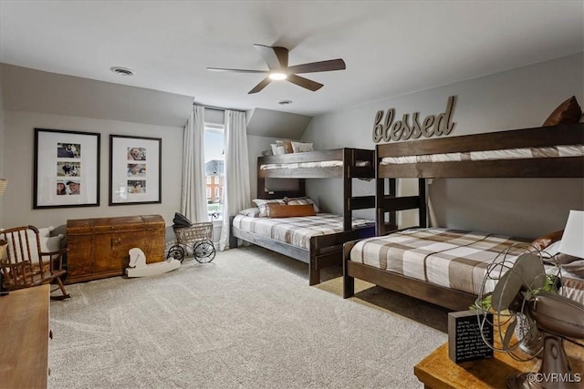 bedroom with lofted ceiling, ceiling fan, and carpet flooring