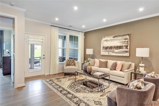 living room featuring crown molding and light wood-type flooring