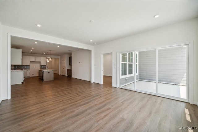 unfurnished living room with wood-type flooring