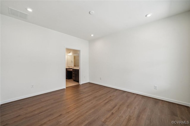 spare room featuring dark hardwood / wood-style floors