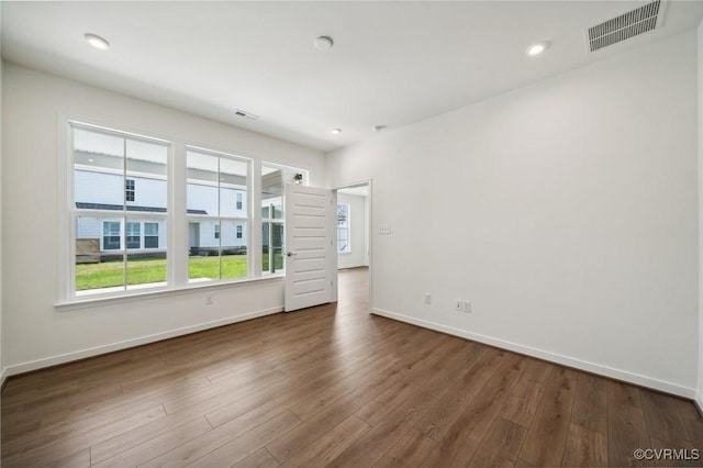 unfurnished room featuring dark wood-type flooring