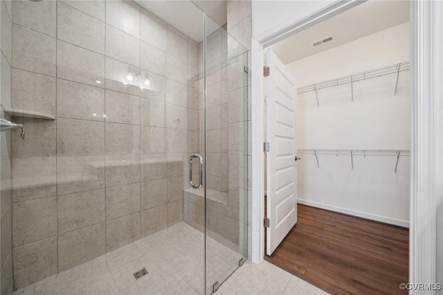 bathroom featuring an enclosed shower and tile patterned flooring