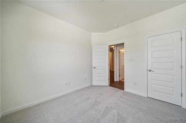 unfurnished bedroom featuring light carpet