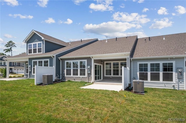 rear view of house featuring a patio, a yard, and central AC unit