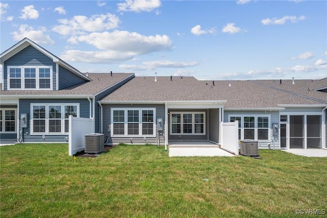 rear view of house featuring central AC unit, a yard, and a patio area