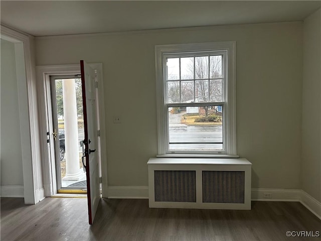 entryway with radiator and hardwood / wood-style flooring