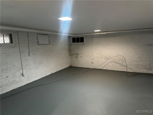 basement featuring brick wall