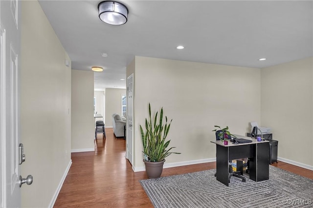 corridor with hardwood / wood-style floors