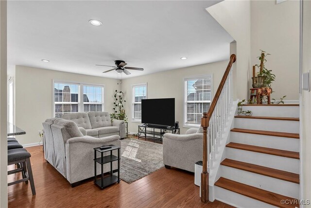 living room with ceiling fan and dark hardwood / wood-style floors