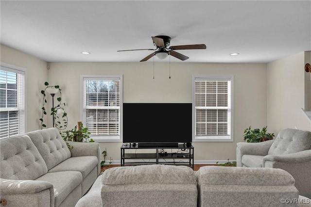 living room with hardwood / wood-style flooring, ceiling fan, and a healthy amount of sunlight