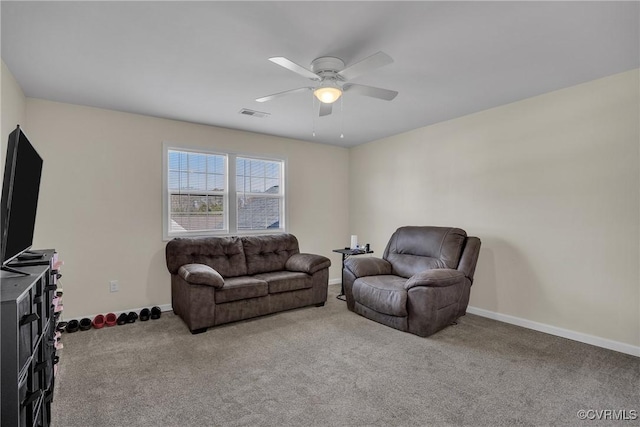 carpeted living room with ceiling fan