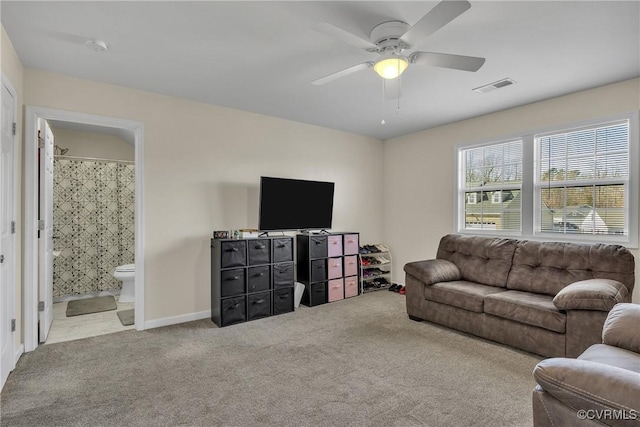 carpeted living room with ceiling fan