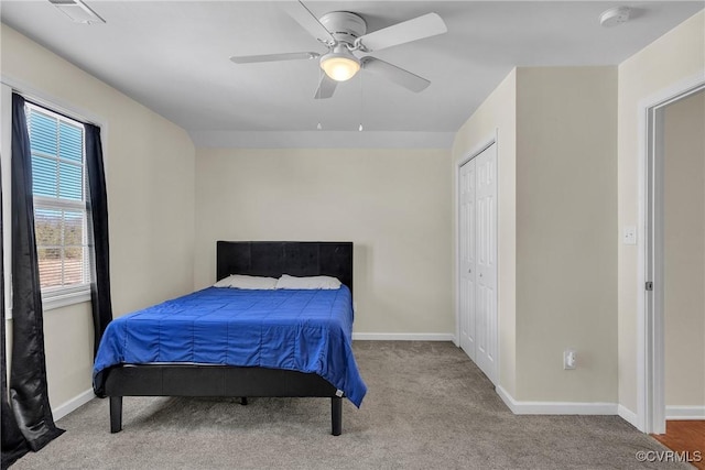 bedroom featuring ceiling fan, light colored carpet, and a closet