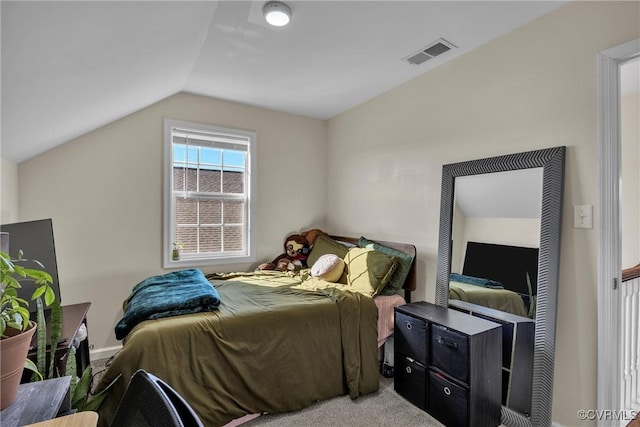 carpeted bedroom with vaulted ceiling