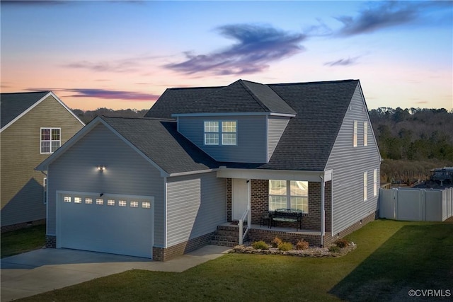 view of front of house with a garage and a yard