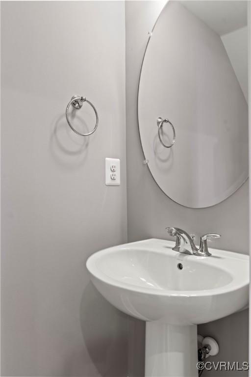 bathroom with lofted ceiling and sink