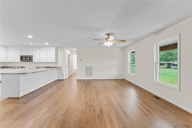 unfurnished living room featuring light hardwood / wood-style floors and ceiling fan