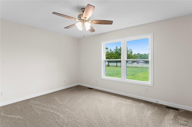 spare room with carpet flooring and ceiling fan