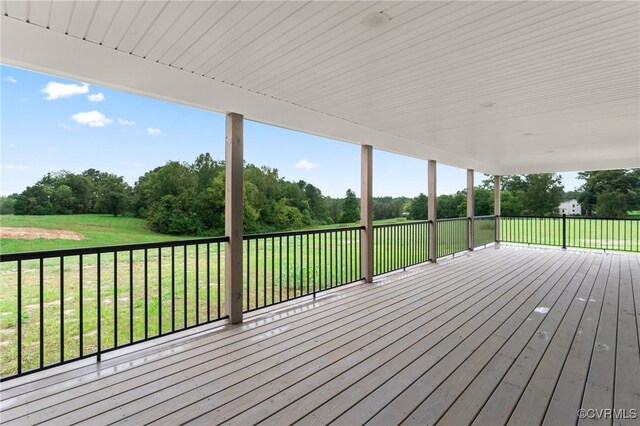 wooden terrace with a lawn