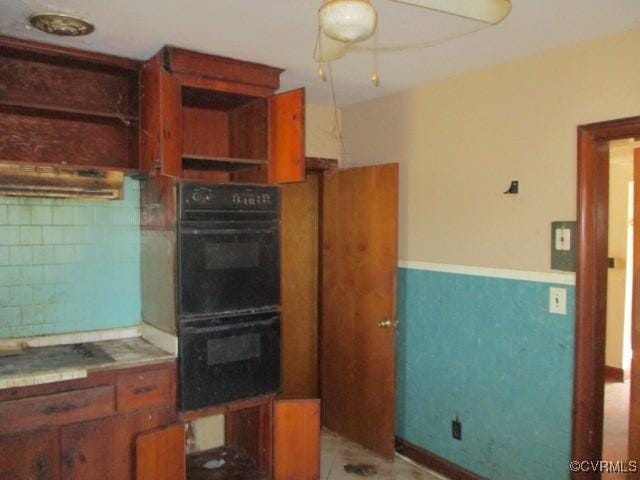 kitchen featuring black double oven and ceiling fan