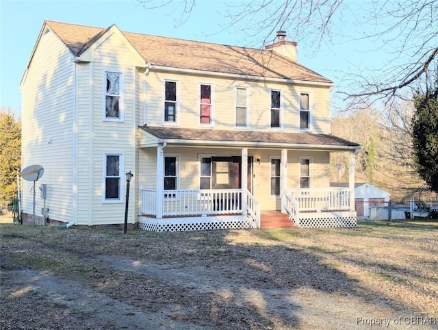 view of front of property with covered porch and a front yard