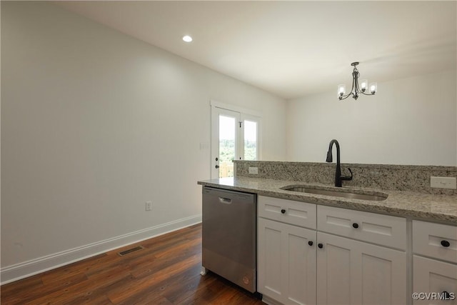 kitchen featuring sink, white cabinetry, hanging light fixtures, dishwasher, and light stone countertops