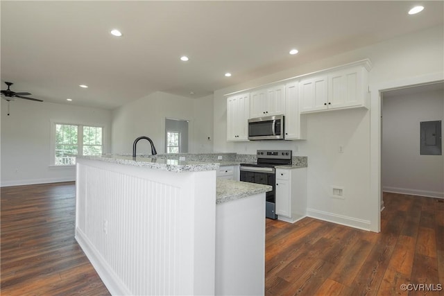 kitchen with stainless steel appliances, dark wood-type flooring, white cabinets, and electric panel