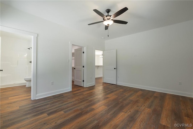 unfurnished bedroom featuring a spacious closet, dark hardwood / wood-style floors, ceiling fan, and ensuite bathroom