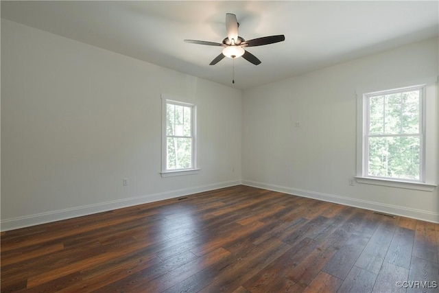 spare room with ceiling fan and dark hardwood / wood-style floors