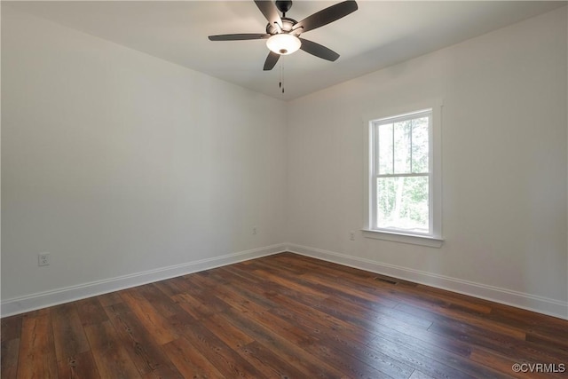 empty room featuring ceiling fan and dark hardwood / wood-style flooring