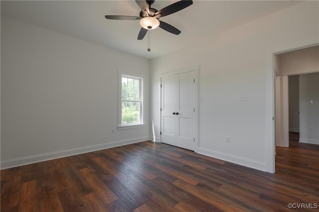 interior space with dark hardwood / wood-style flooring, a closet, and ceiling fan