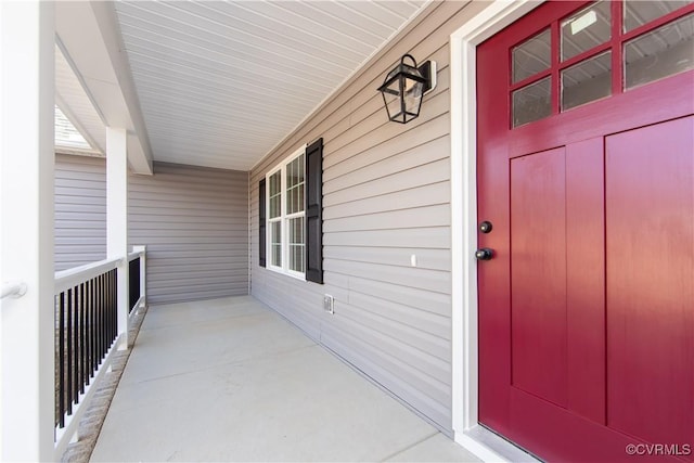 view of exterior entry featuring a porch