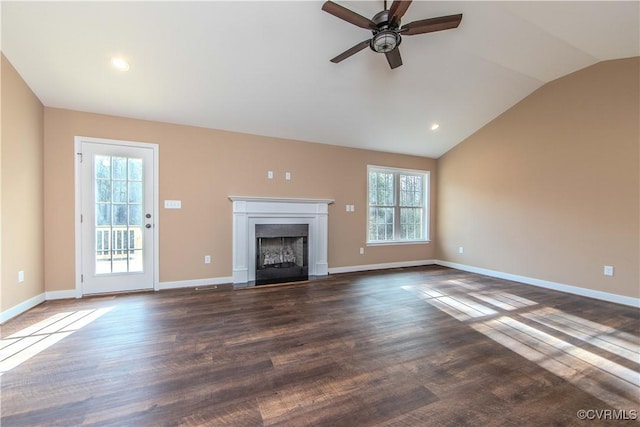 unfurnished living room featuring ceiling fan, lofted ceiling, plenty of natural light, and dark hardwood / wood-style flooring