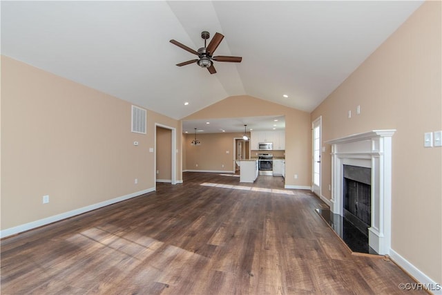 unfurnished living room featuring dark wood-type flooring, ceiling fan, and vaulted ceiling