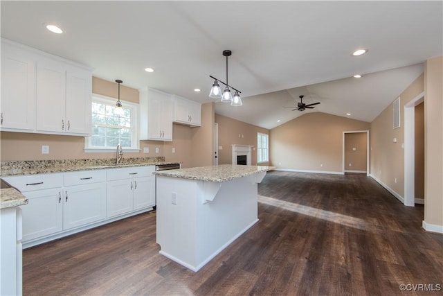 kitchen with white cabinetry, a kitchen island, and pendant lighting