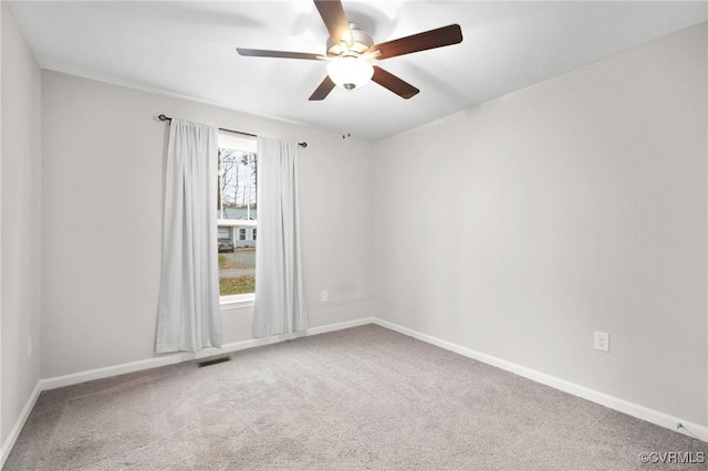 spare room featuring ceiling fan and carpet flooring