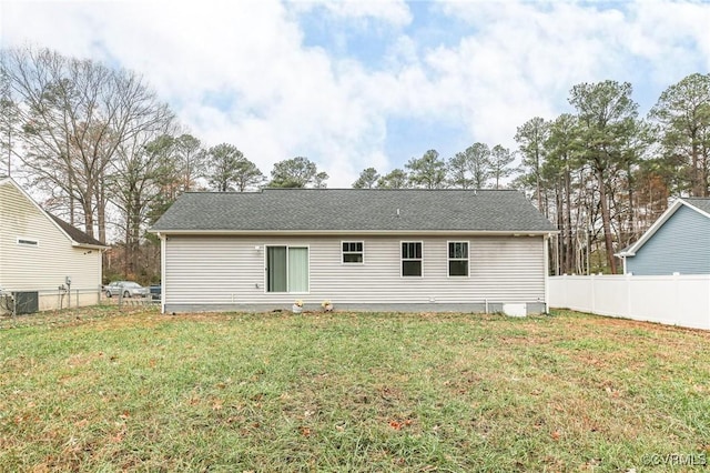 back of property with a yard and central air condition unit