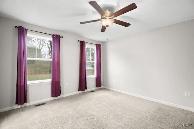 carpeted spare room with ceiling fan