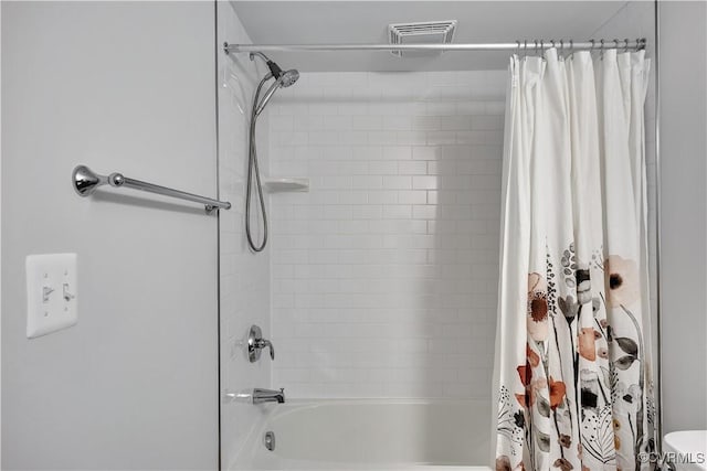 bathroom with toilet and shower / bath combo